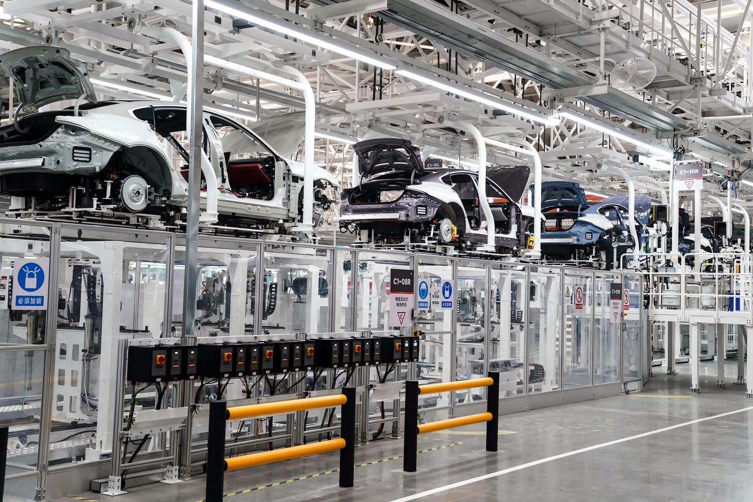 Clear acrylic machine guarding along an automotive assembly line