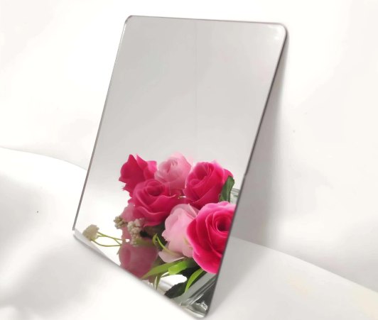 Silver acrylic mirror panel with polished edge reflecting flowers