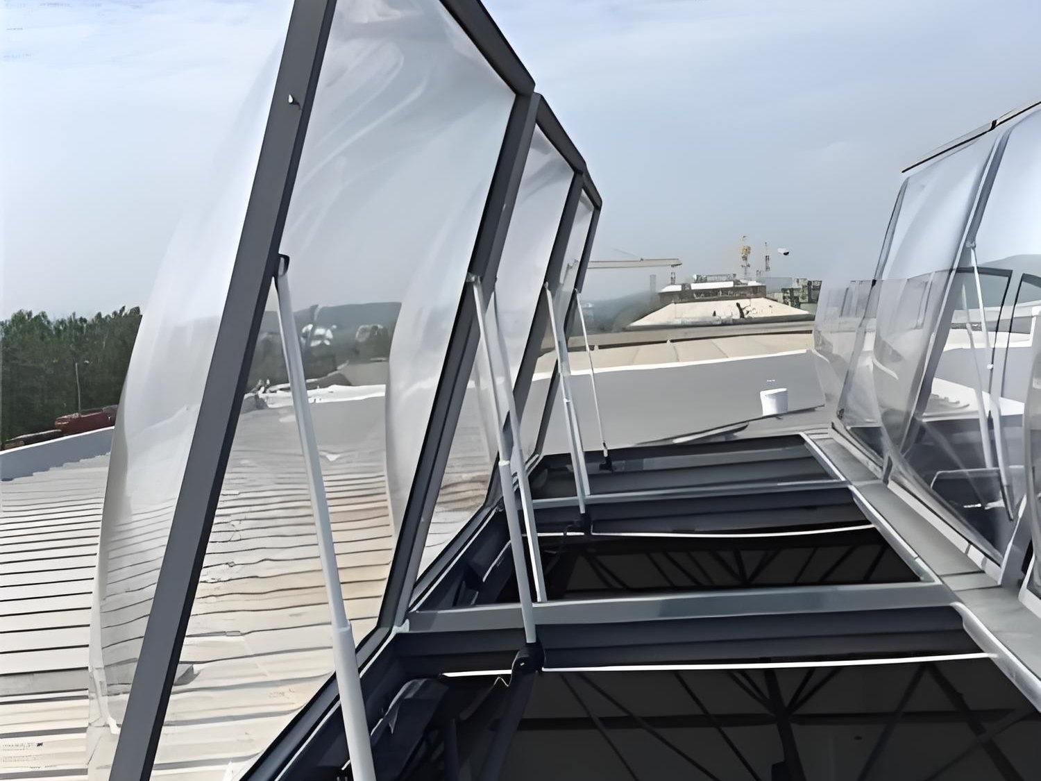 Opening acrylic rooflight vents on an industrial roof