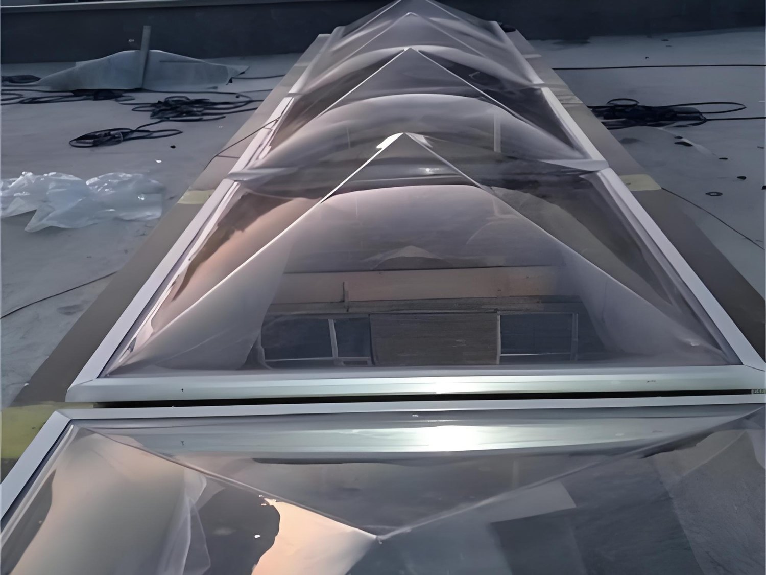Pyramid acrylic skylight dome installed on a roof with protective film still in place