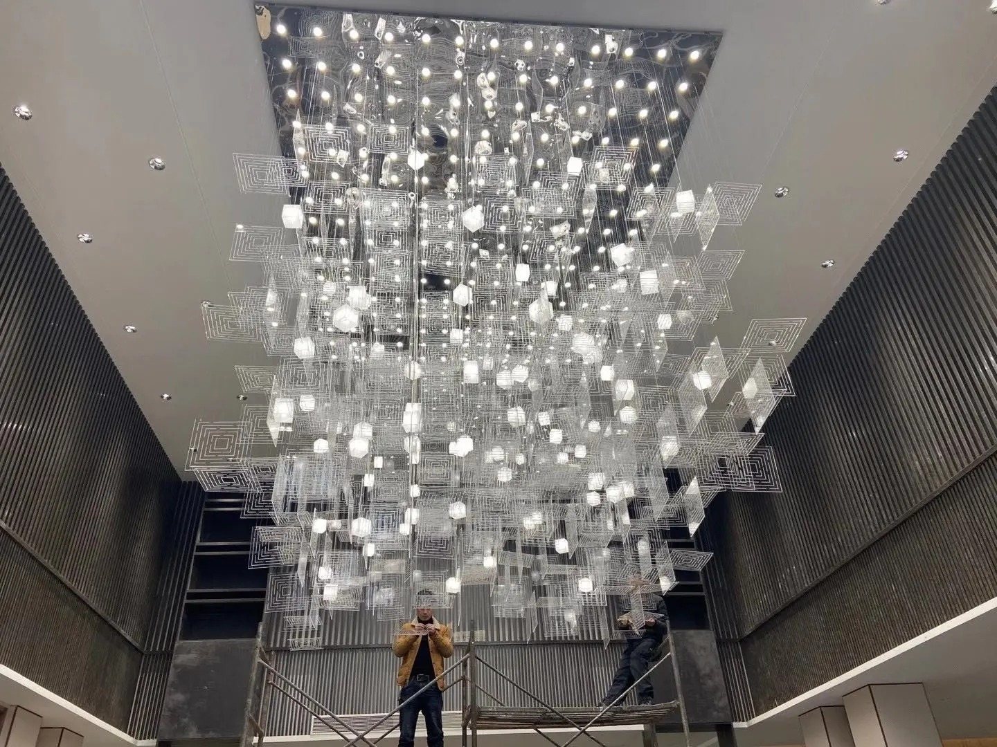 Suspended acrylic sphere ceiling feature in a lobby
