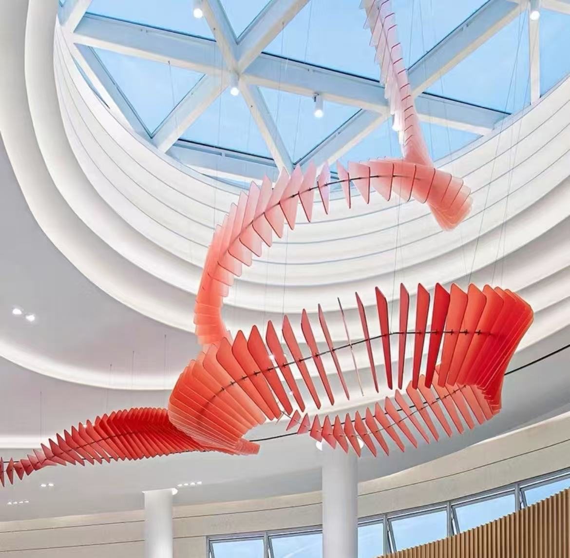 Red acrylic spiral suspended feature in an atrium