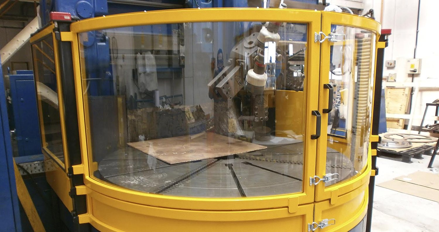 Curved acrylic safety guard on rotating machinery