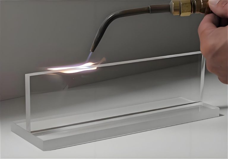 Flame polishing the edge of a clear acrylic block to optical clarity