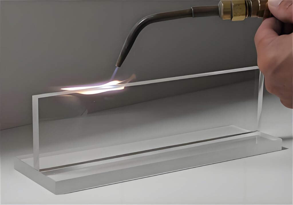 Flame polishing the edge of a clear acrylic block to optical clarity